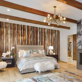 bedroom with wood ceiling beams and raw wood floor