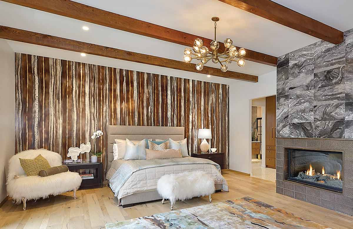 bedroom with wood ceiling beams and raw wood floor