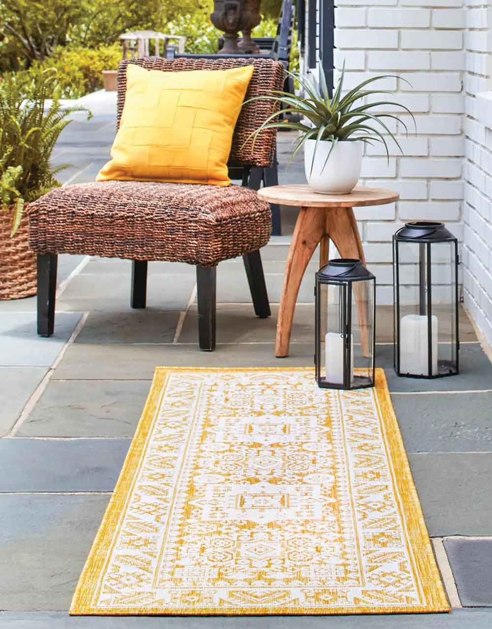 yellow outdoor rug and wicker chair